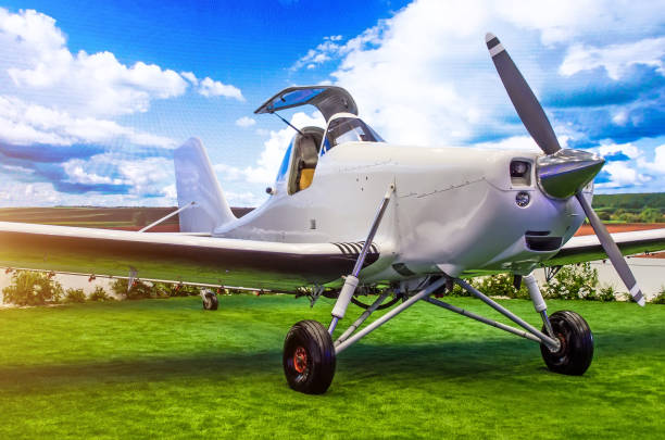 istock Turboprop aircraft with open cockpit pilot in the meadow. 875983504