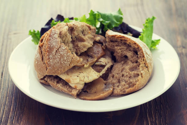 istock sandwich with chicken and mushrooms on white plate 875983938