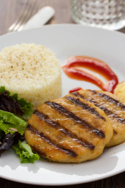 istock grilled meat with boiled rice and salad on white dish 875984094