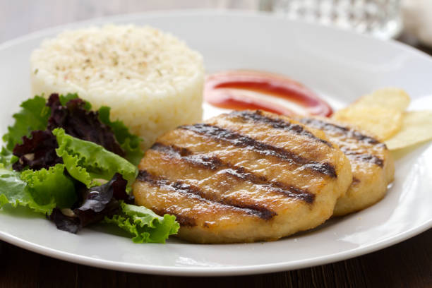 istock grilled hamburger with boiled rice, salad and chips on plate 875984098