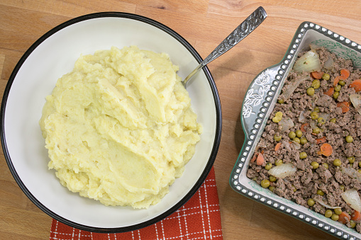 Food preparation of Shepherd's Pie made with ground beed, vegetables and mashed potatoes