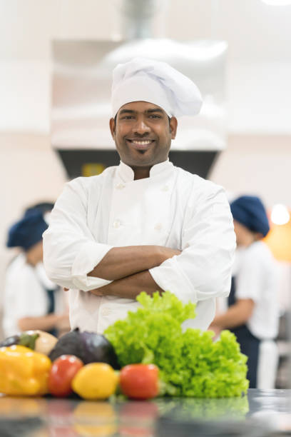 istock Indian chef at his restaurant looking at the camera smiling with arms crossed 875991950