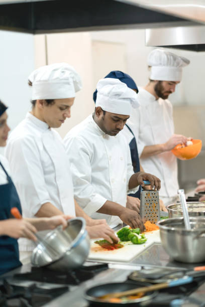istock Multi ethnic group cooking meals at a kitchen's restaurant 875991998