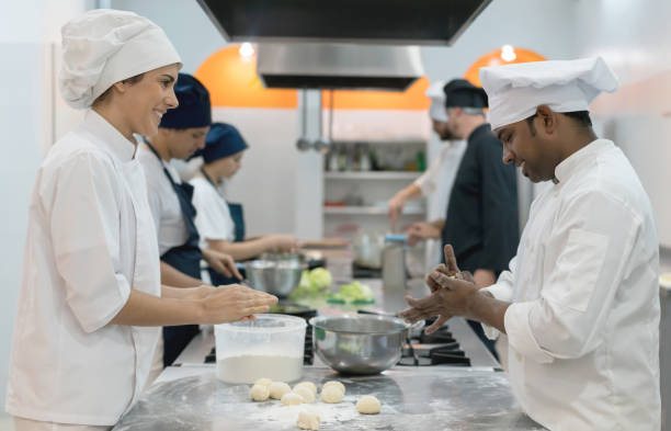 istock Chefs kneading dough to bake bread looking happy and smiling 875992058