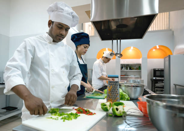 istock Chef, sous chef and cooking assistant working on different things at the restaurants kitchen 875992066