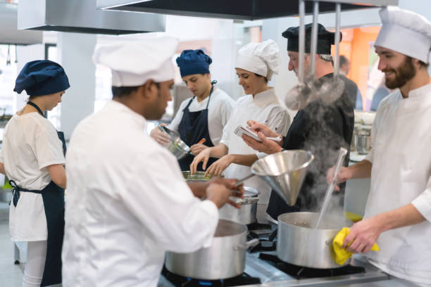 istock Chef asking his team what they need to buy and making a list on a notepad 875992172