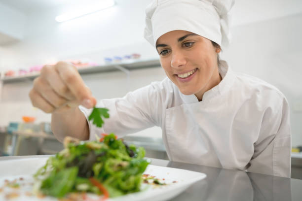 istock Pretty latin american chef making a salad and looking very happy 875992328