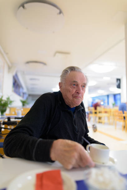 istock Senior man eating at the cafeteria in nursing home 875993518
