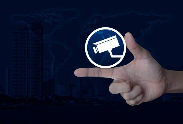 cctv camera icon on finger over world map and modern city tower, Business security concept, Elements of this image furnished by NASA