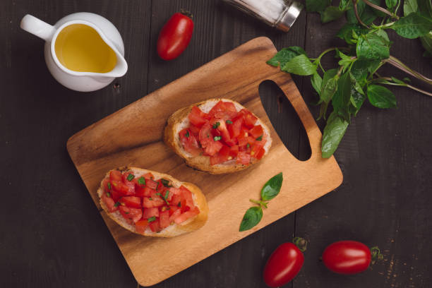 istock Simple italian appetizing bruschetta with tomato, on wooden table 875999412