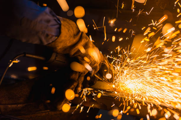 istock Worker using electric wheel grinding on steel structure in factory. 876001014