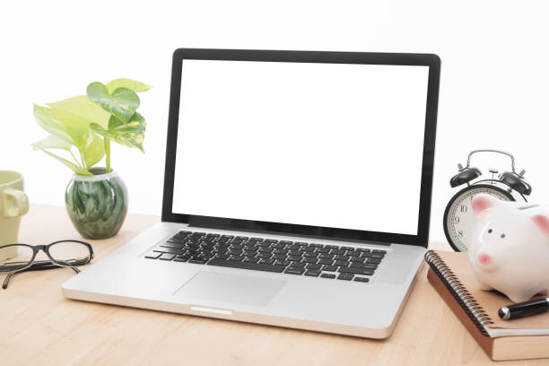 istock workplace with modern computer white screen and book, glasses, piggy bank, coffee cup on desk office. 876003340