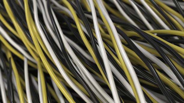 istock Twisted black, white and yellow cables and wires on black surface 876015324