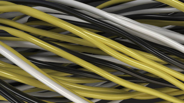 istock Twisted black, white and yellow cables and wires on black surface 876015402