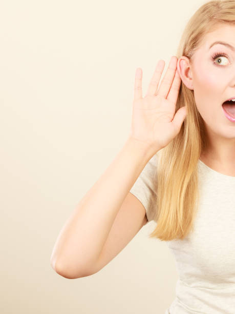 istock Woman putting hand ear to hear better 876015408