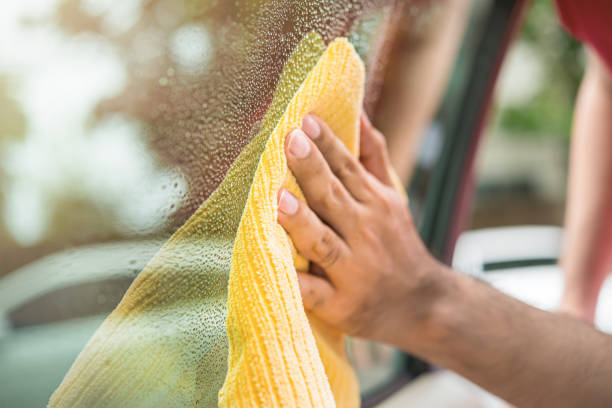 istock Auto care service staff cleanining car window glass 876018790