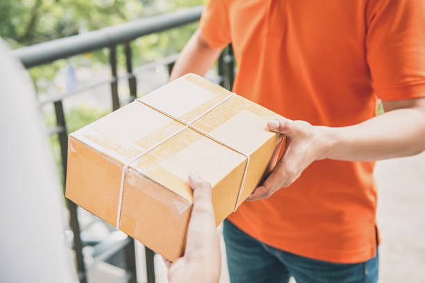 Delivery man giving a parcel box to a customer