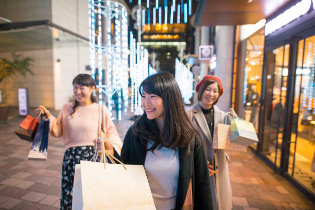 istock Young women in city shopping after work 876019924