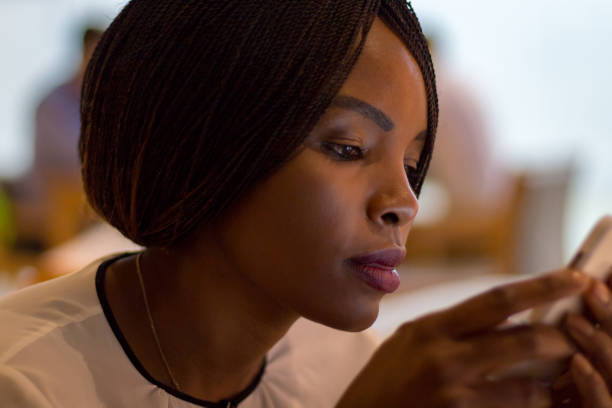 istock African woman text message on her cellphone 876022374