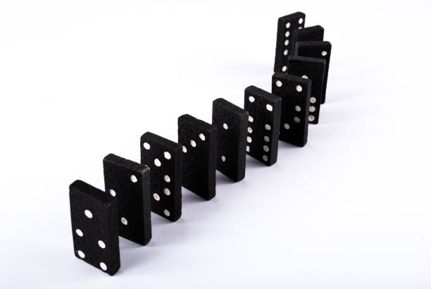 istock Black domino tiles in a row isolated on white background 876025800