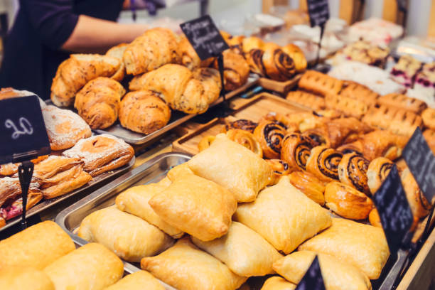 istock Close up freshly baked pastry goods on display in bakery shop. Selective focus 876026328
