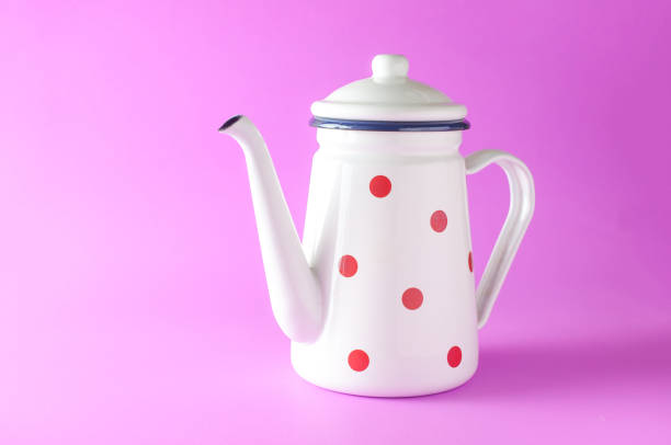 Old enamel tea pot, isolated on white