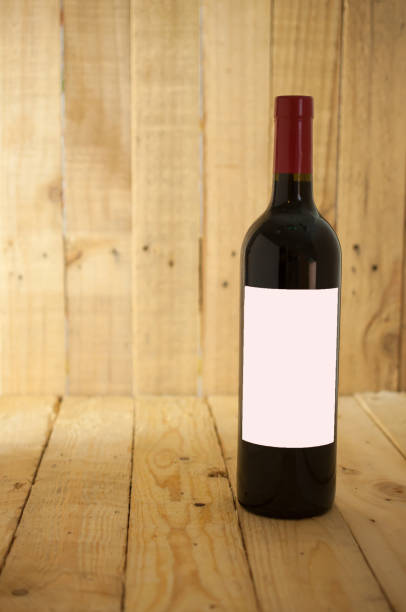 istock Red wine bottle with empty glass and white label for branding communication 876029554