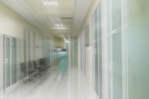 Blurry image of hospital corridor in front of Operation rooms.Hospital blur background with Nurse.