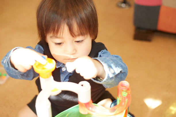 istock Baby boy focused on his toy 876040972