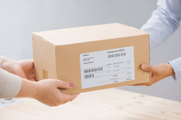 istock Woman receiving package from a delivery man 876045498