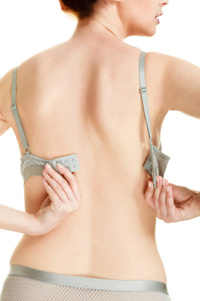 istock Attractive slim woman taking off grey bra 876056054