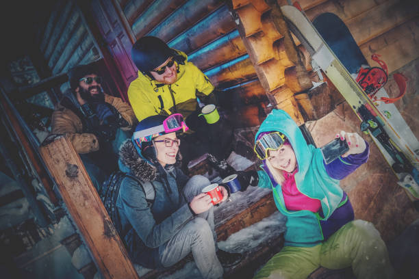 istock Snowboarders sitting outside and taking selfie 876062800