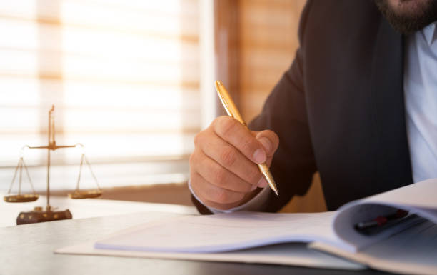 istock Caucasian lawyer signing documents  in office 876067312