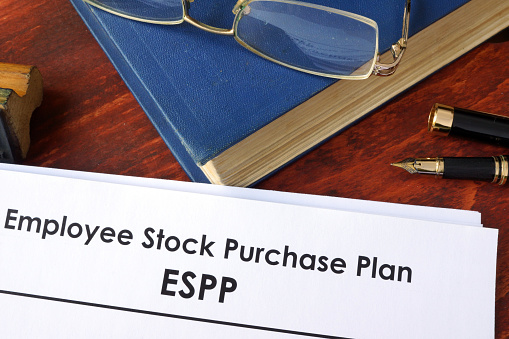 Papers with ESPP Employee Stock Purchase Plan on a table.
