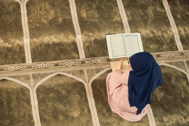 istock muslim woman praying in mosque 876071214