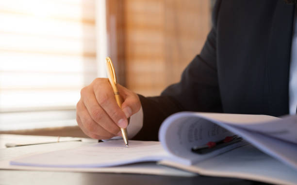 istock Caucasian lawyer signing documents  in office 876071994
