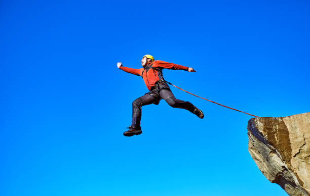 istock Jump off the cliff with a rope. 876074846