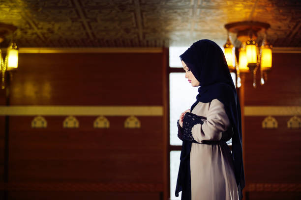 istock muslim woman praying in mosque 876078548