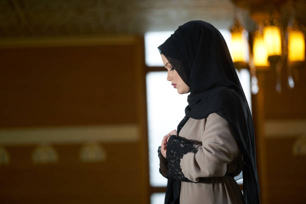 istock muslim woman praying in mosque 876078822