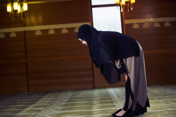istock muslim woman praying in mosque 876081856