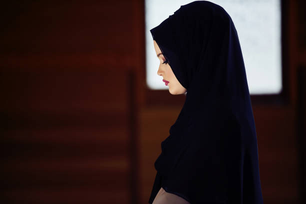 istock muslim woman praying in mosque 876086700