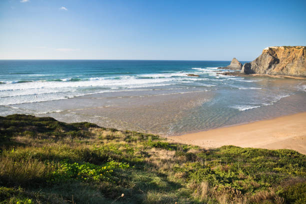 istock visiting stunning beach Praia de Odeceixe by atlantic ocean in sunny blue sky, portugal 876086840