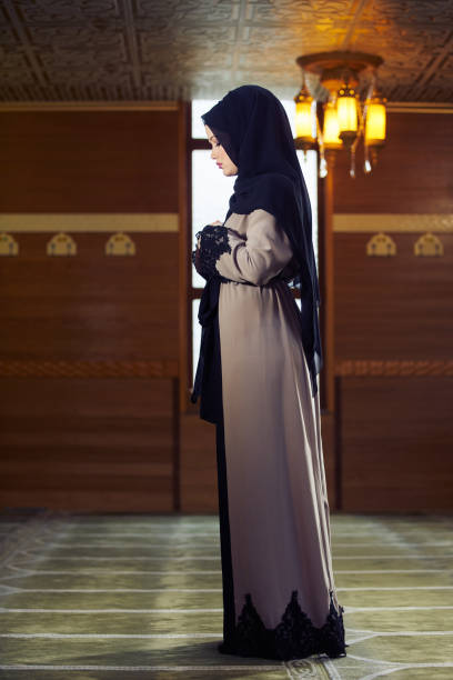 istock muslim woman praying in mosque 876089828