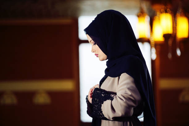 istock muslim woman praying in mosque 876090324