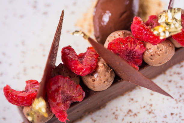 Chocolate dessert with raspberries and gold