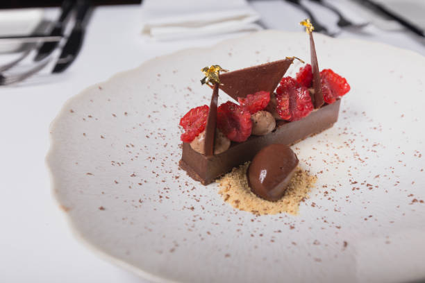 Chocolate dessert with raspberries and gold