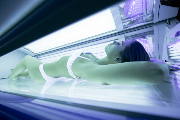 istock Beautiful brunette sunbathing in solarium 876121480