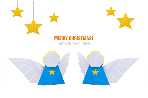 Christmas origami angels with stars decorations in paper on a white background