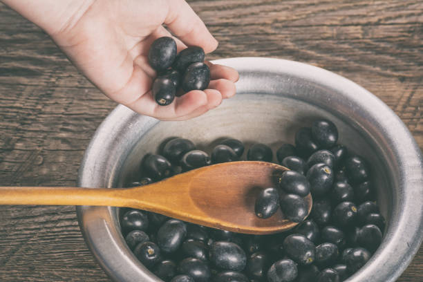 olives in hand - cooking oil olive oil nutritional supplement spoon imagens e fotografias de stock