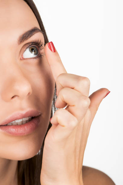 istock woman applying contact lens 876129332